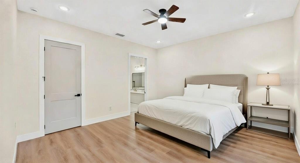 257 Lago Vista Street DeBary, FL 32713 - Photo 22 of 35 a bedroom with a bed and a chandelier