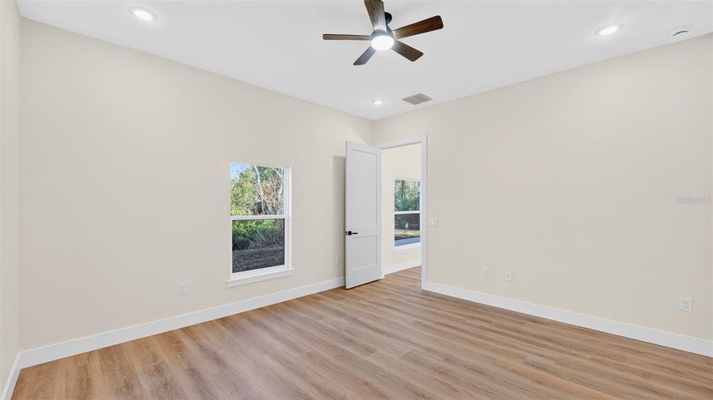 257 Lago Vista Street DeBary, FL 32713 - Photo 23 of 35 wooden floor in an empty room with a window