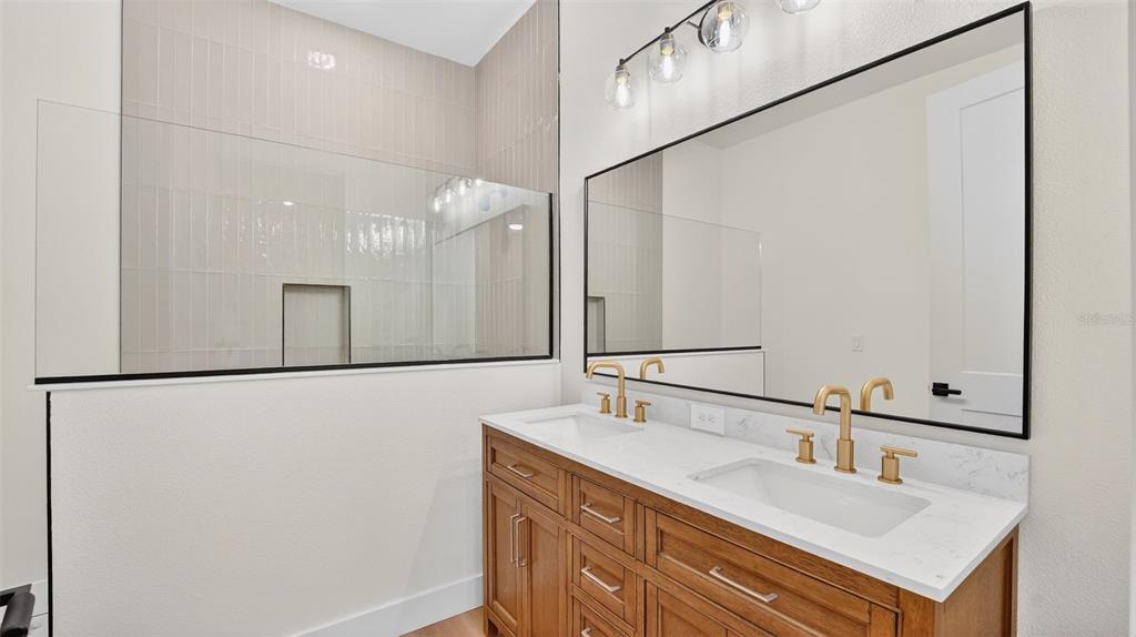 257 Lago Vista Street DeBary, FL 32713 - Photo 25 of 35 a bathroom with a sink and a mirror