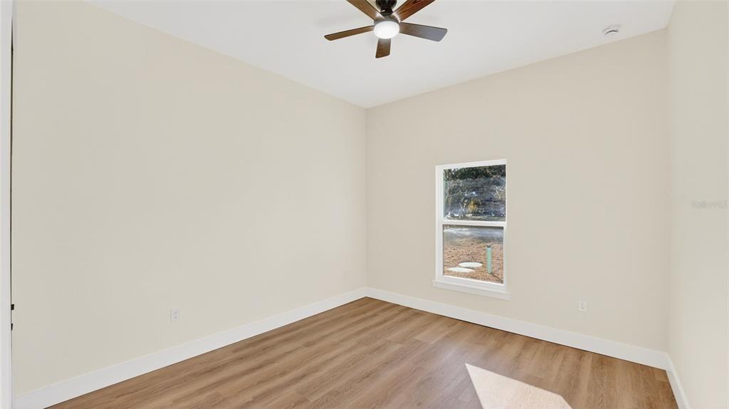 257 Lago Vista Street DeBary, FL 32713 - Photo 27 of 35 a view of an empty room with wooden floor and a window