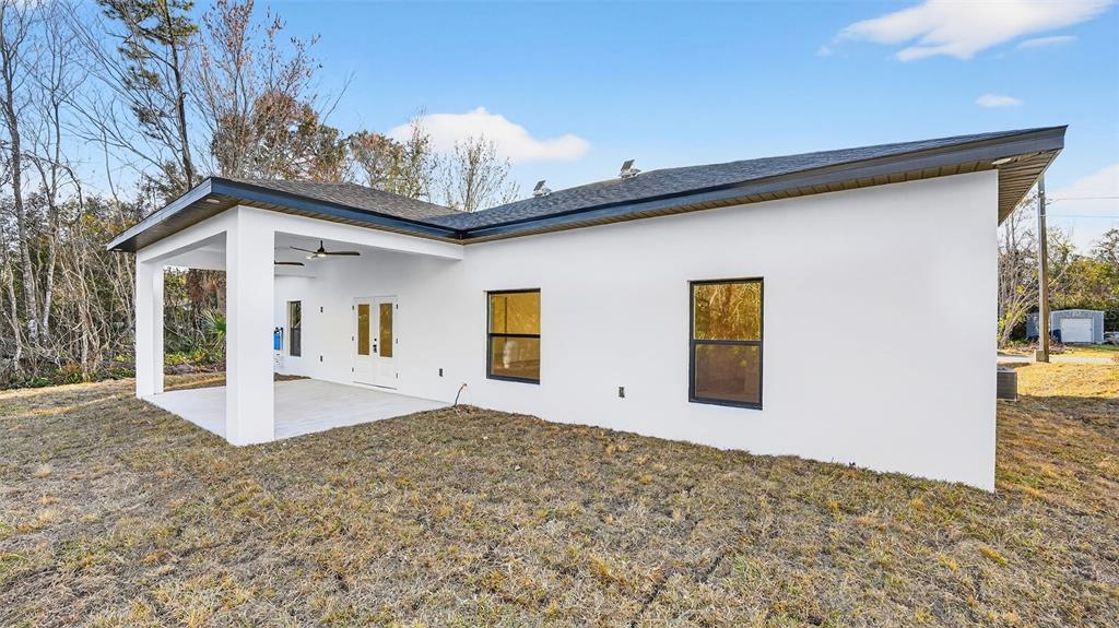 257 Lago Vista Street DeBary, FL 32713 - Photo 34 of 35 a front view of a house with a yard and garage