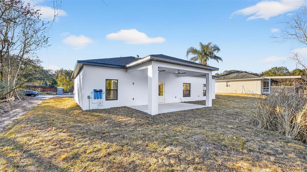 257 Lago Vista Street DeBary, FL 32713 - Photo 35 of 35 a view of a white house with a yard