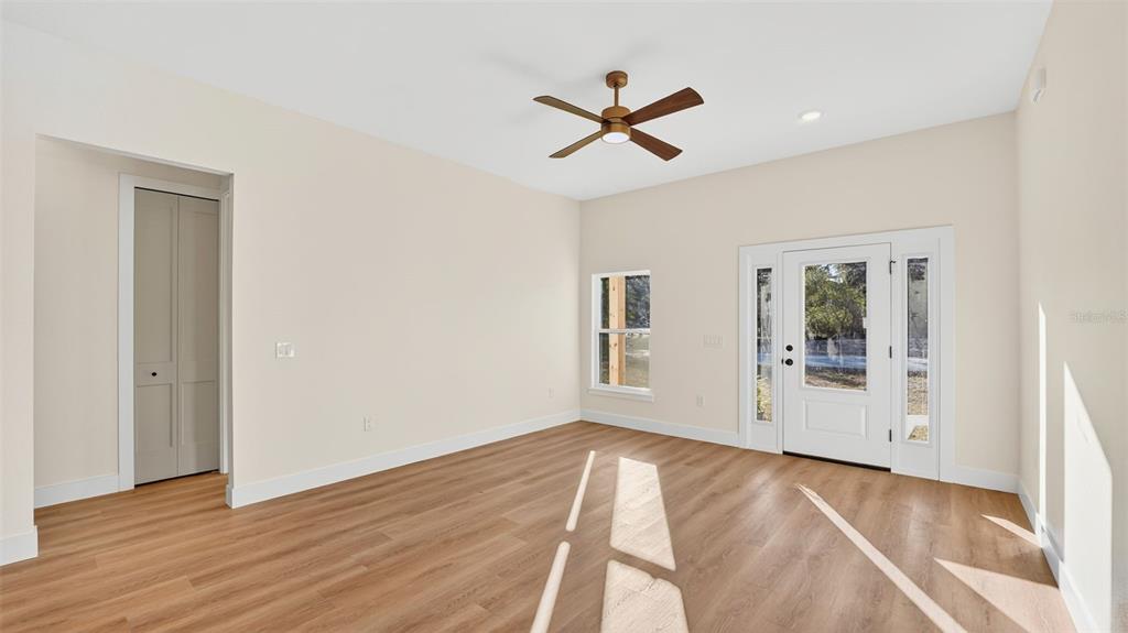 257 Lago Vista Street DeBary, FL 32713 - Photo 5 of 35 a view of empty room with wooden floor and fan