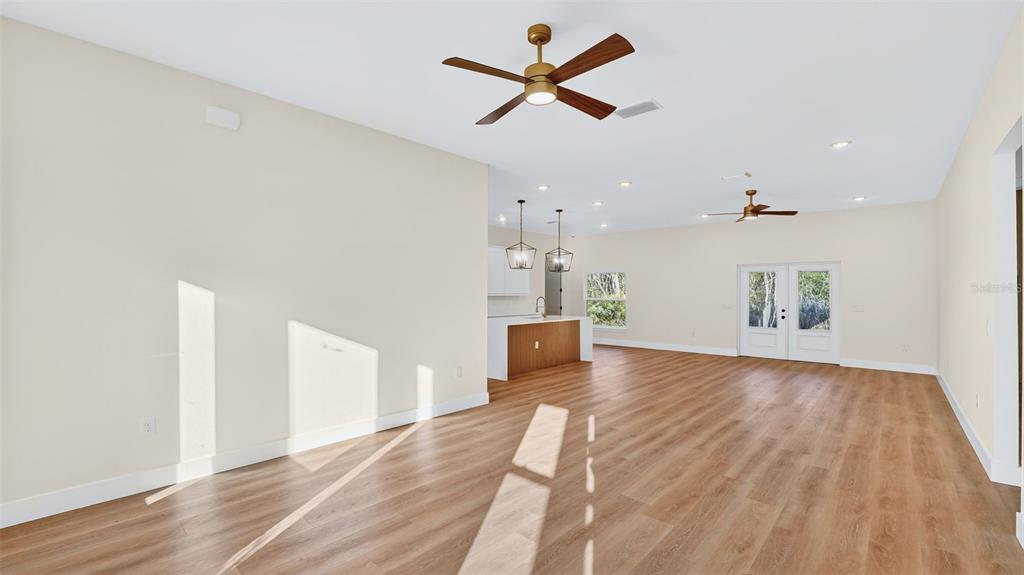 257 Lago Vista Street DeBary, FL 32713 - Photo 6 of 35 wooden floor in an empty room with a window