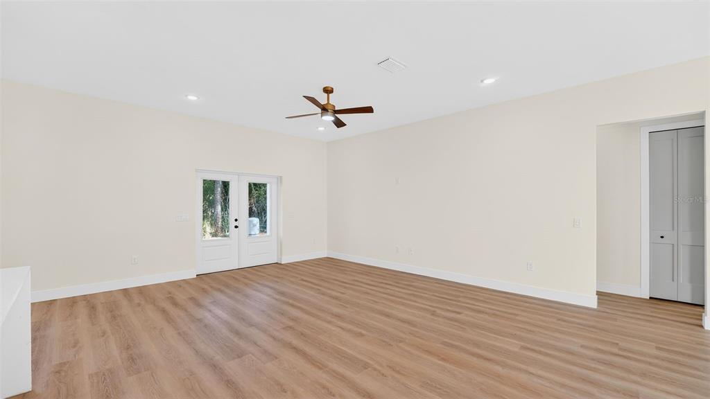 257 Lago Vista Street DeBary, FL 32713 - Photo 8 of 35 wooden floor in an empty room with a window