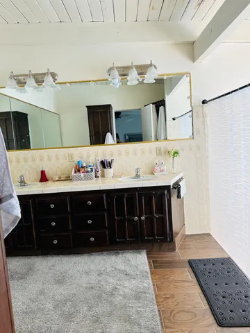 a bathroom with a tub sink and cabinets