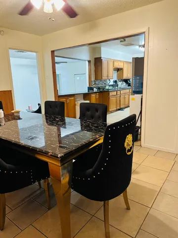 a living room with kitchen island a table and chairs