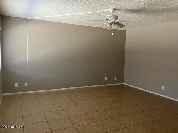 a view of an empty room with a ceiling fan