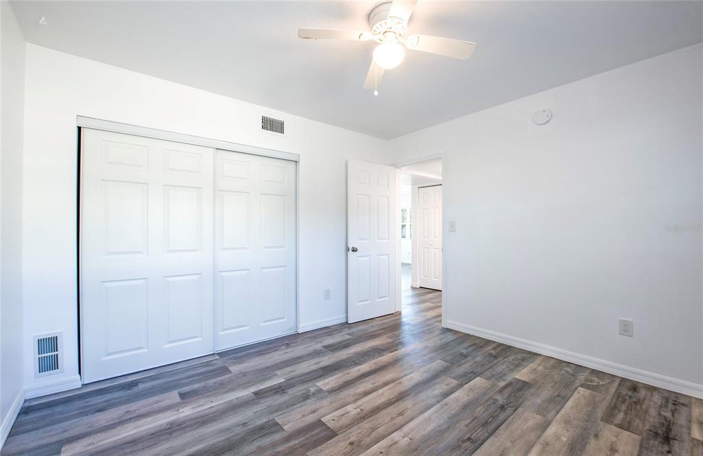 717 East Gulf Boulevard Indian Rocks Beach, FL 33785 - Photo 13 of 65 a view of an empty room with wooden floor