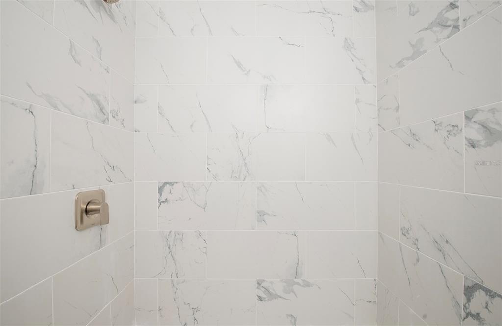 717 East Gulf Boulevard Indian Rocks Beach, FL 33785 - Photo 36 of 65 a bathroom with a shower