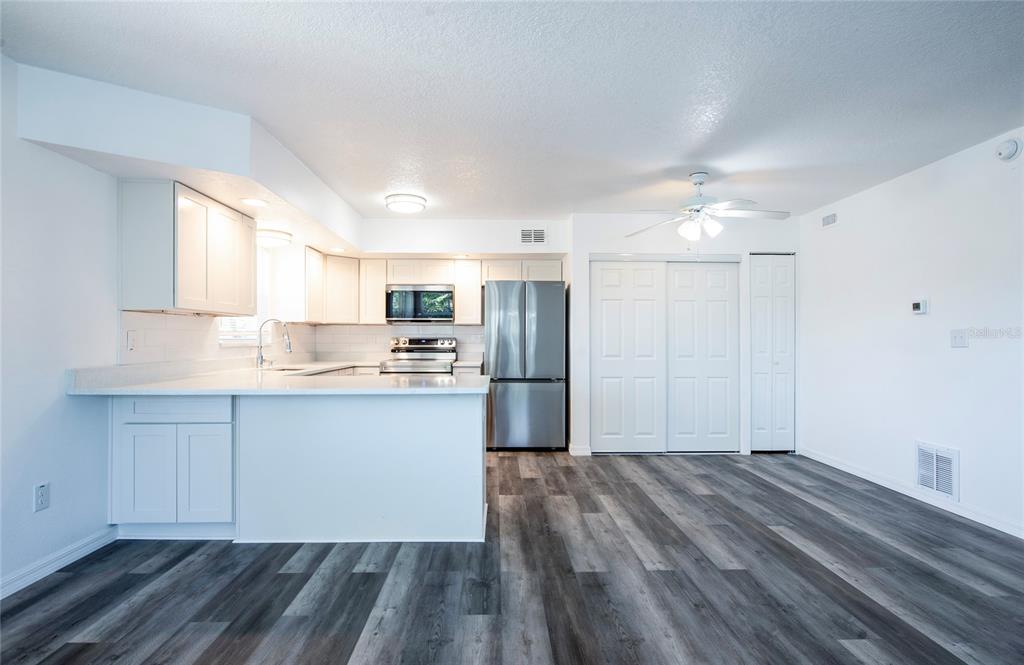 717 East Gulf Boulevard Indian Rocks Beach, FL 33785 - Photo 43 of 65 a kitchen with granite countertop a refrigerator and a sink