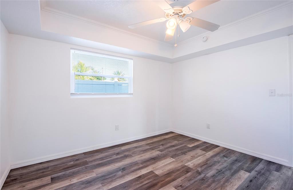 717 East Gulf Boulevard Indian Rocks Beach, FL 33785 - Photo 47 of 65 an empty room with a window and ceiling fan