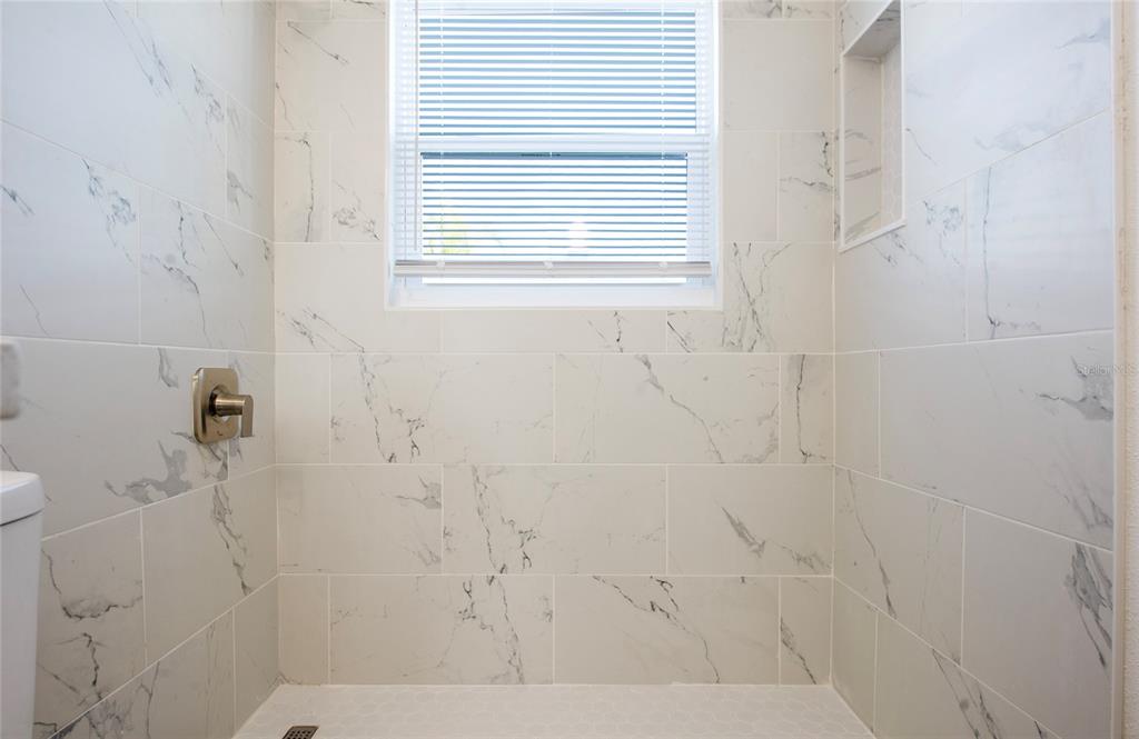 717 East Gulf Boulevard Indian Rocks Beach, FL 33785 - Photo 50 of 65 a bathroom with a window and a shower