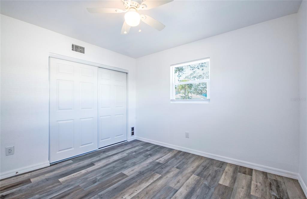 717 East Gulf Boulevard Indian Rocks Beach, FL 33785 - Photo 5 of 65 wooden floor in an empty room with a window