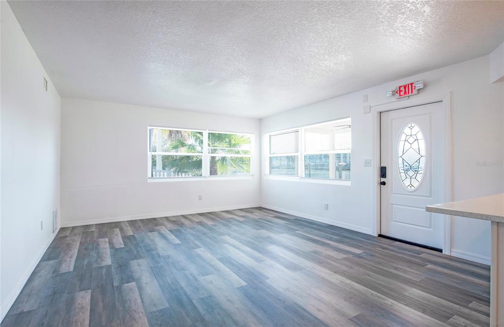 717 East Gulf Boulevard Indian Rocks Beach, FL 33785 - Photo 55 of 65 an empty room with wooden floor and windows