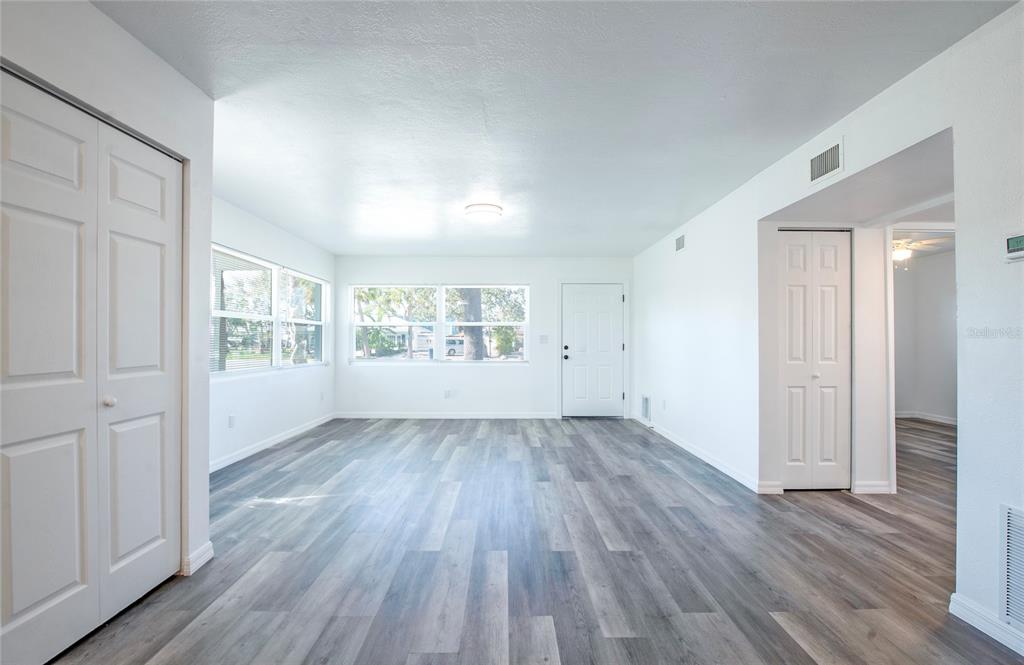 717 East Gulf Boulevard Indian Rocks Beach, FL 33785 - Photo 6 of 65 wooden floor in an empty room with a window