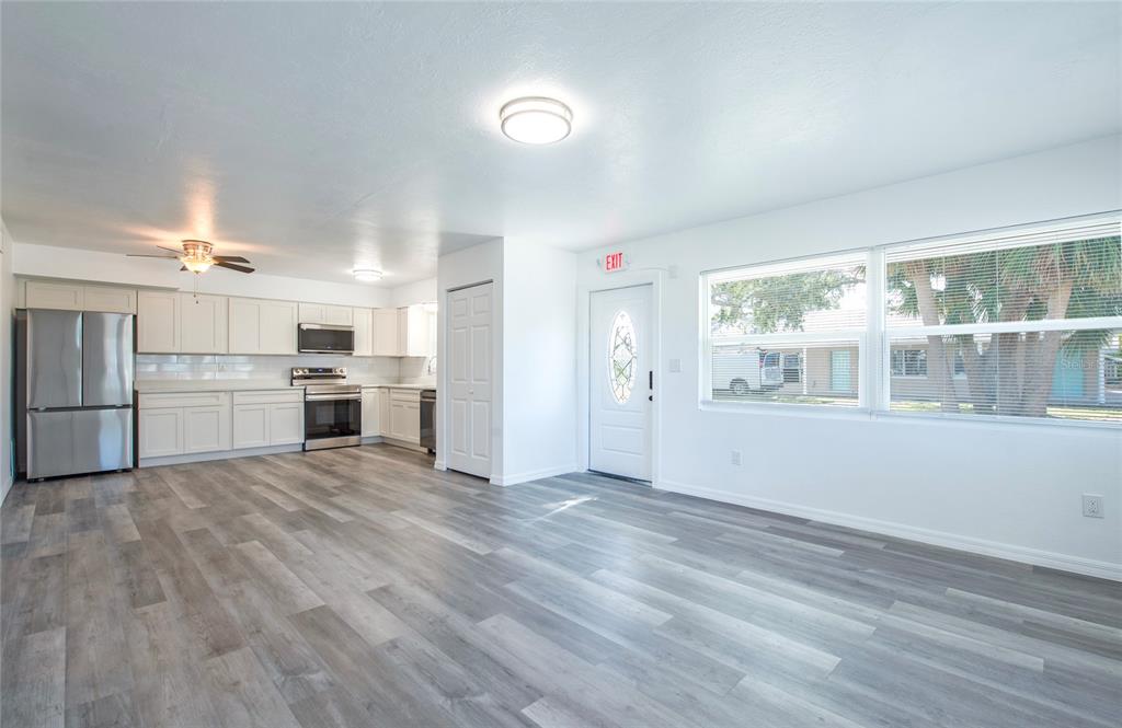 717 East Gulf Boulevard Indian Rocks Beach, FL 33785 - Photo 10 of 65 a view of kitchen with wooden floor and electronic appliances