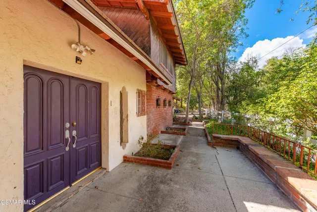 a view of an empty room with a fireplace and a large window