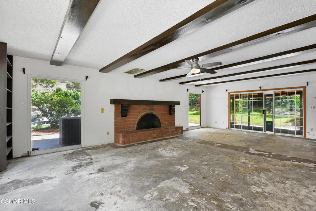 24910 John Fremont Road Hidden Hills, CA 91302 - Photo 13 of 67 a view of an empty room with a fireplace and a window