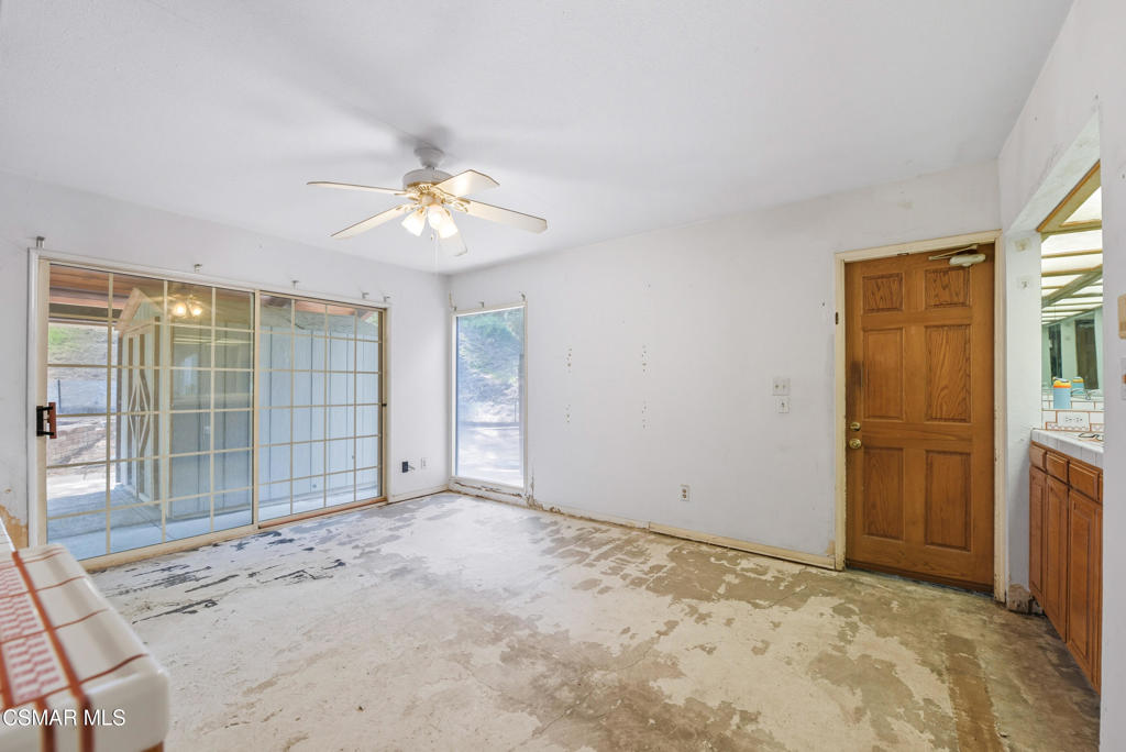 24910 John Fremont Road Hidden Hills, CA 91302 - Photo 19 of 67 a view of a livingroom with a chandelier fan and windows