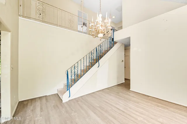 a view of an empty room with a ceiling fan
