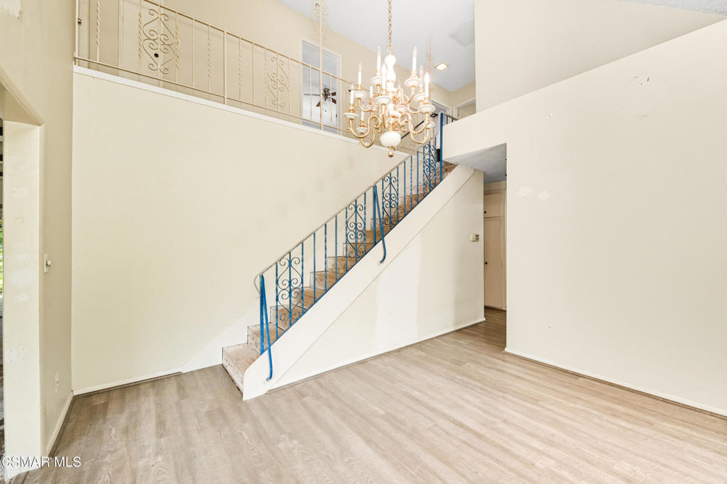 24910 John Fremont Road Hidden Hills, CA 91302 - Photo 26 of 67 a view of a hallway with wooden floor and staircase