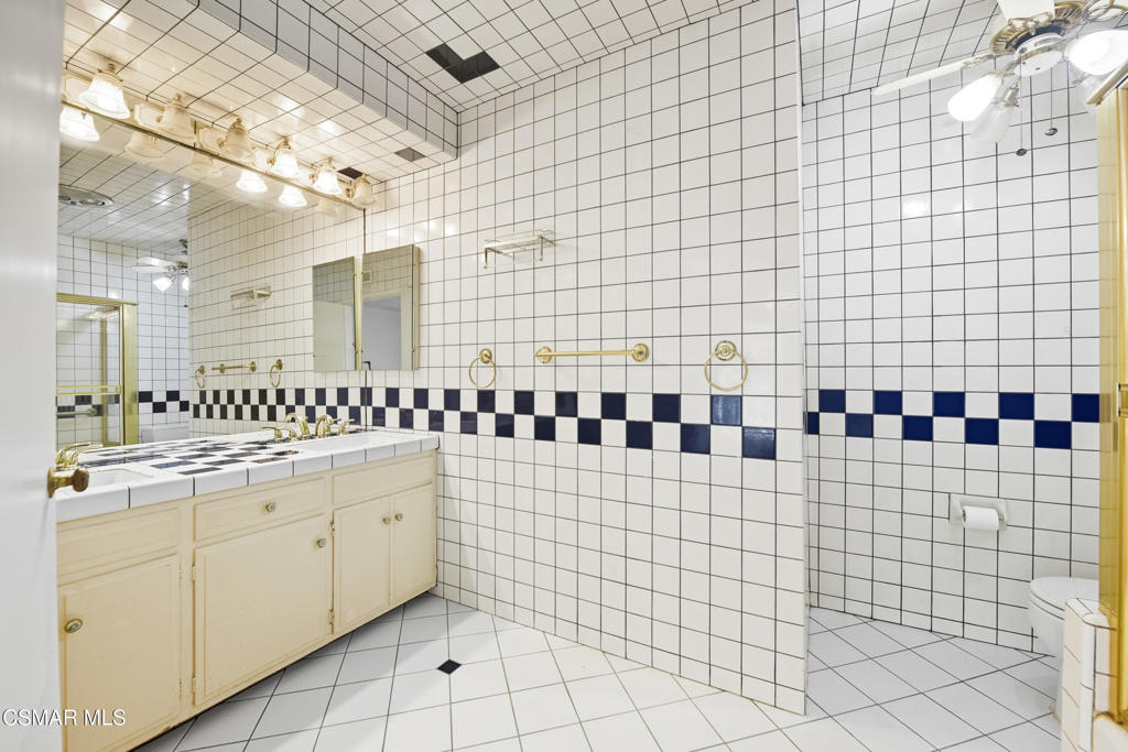 24910 John Fremont Road Hidden Hills, CA 91302 - Photo 33 of 67 a bathroom with a sink a toilet and a shower