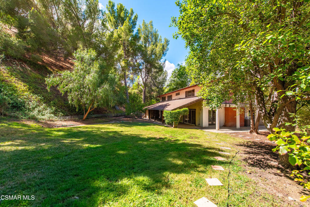 24910 John Fremont Road Hidden Hills, CA 91302 - Photo 41 of 67 a front view of a house with a yard and trees