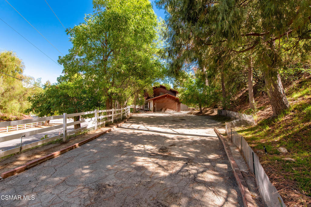 24910 John Fremont Road Hidden Hills, CA 91302 - Photo 45 of 67 a view of a street with trees on both side of it