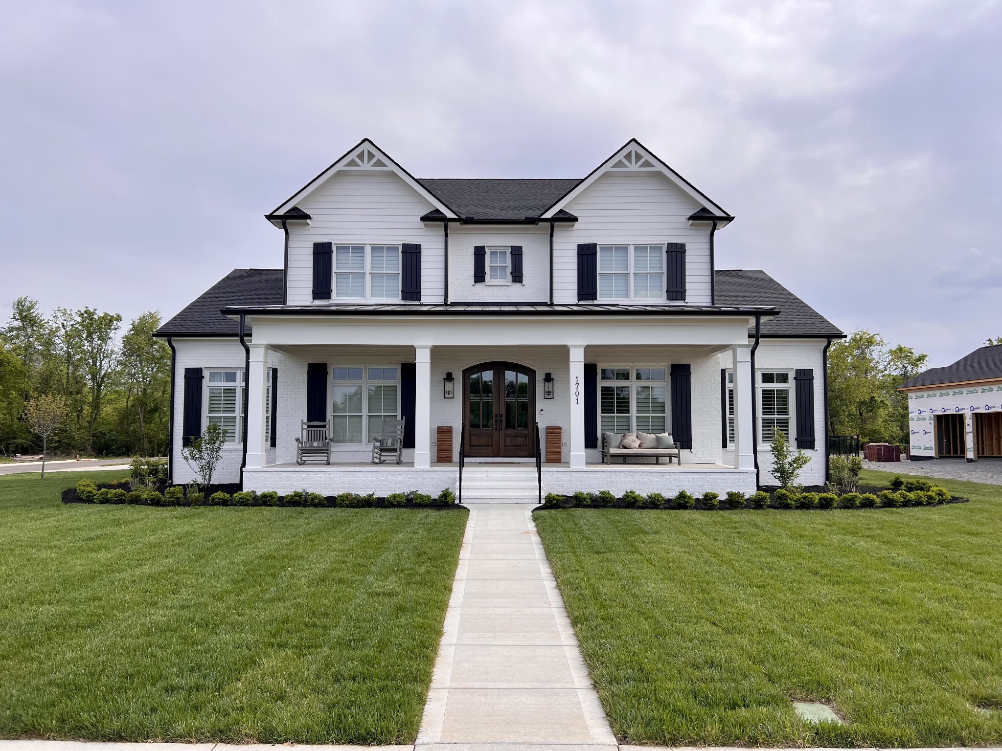 a front view of a house with a yard and porch