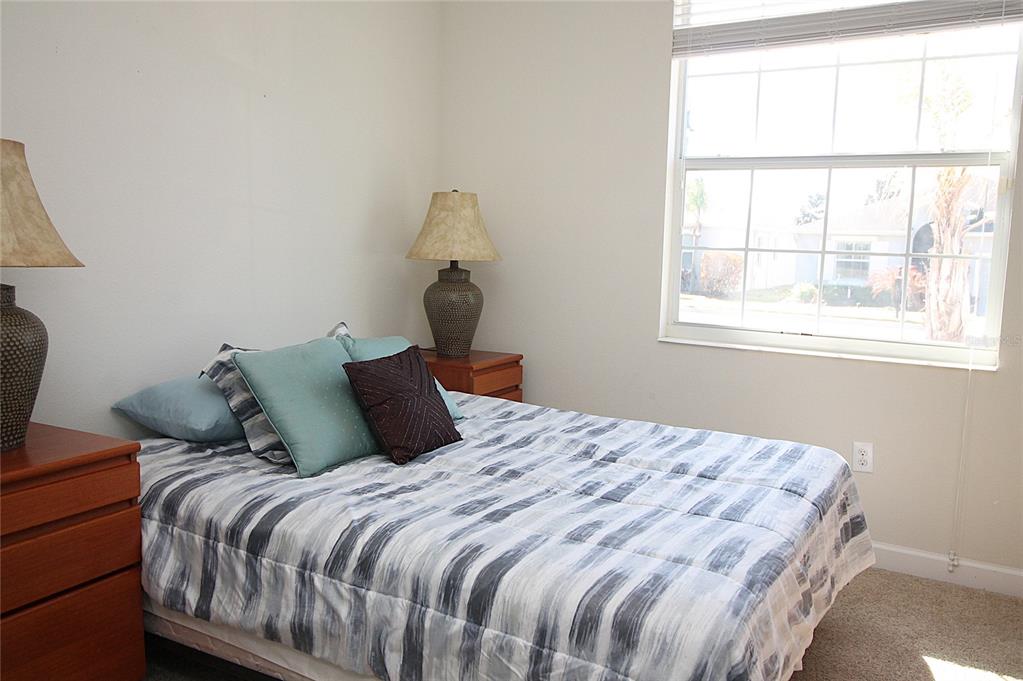 3752 Quaint Lane Clermont, FL 34711 - Photo 14 of 49 a bed sitting in a bedroom next to a window