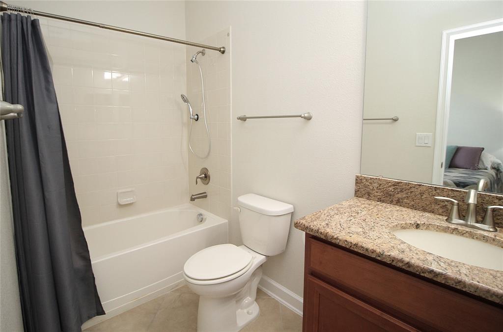 3752 Quaint Lane Clermont, FL 34711 - Photo 18 of 49 a bathroom with a granite countertop sink toilet and shower