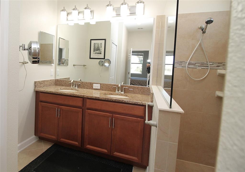 3752 Quaint Lane Clermont, FL 34711 - Photo 19 of 49 a bathroom with a granite countertop sink a mirror and shower