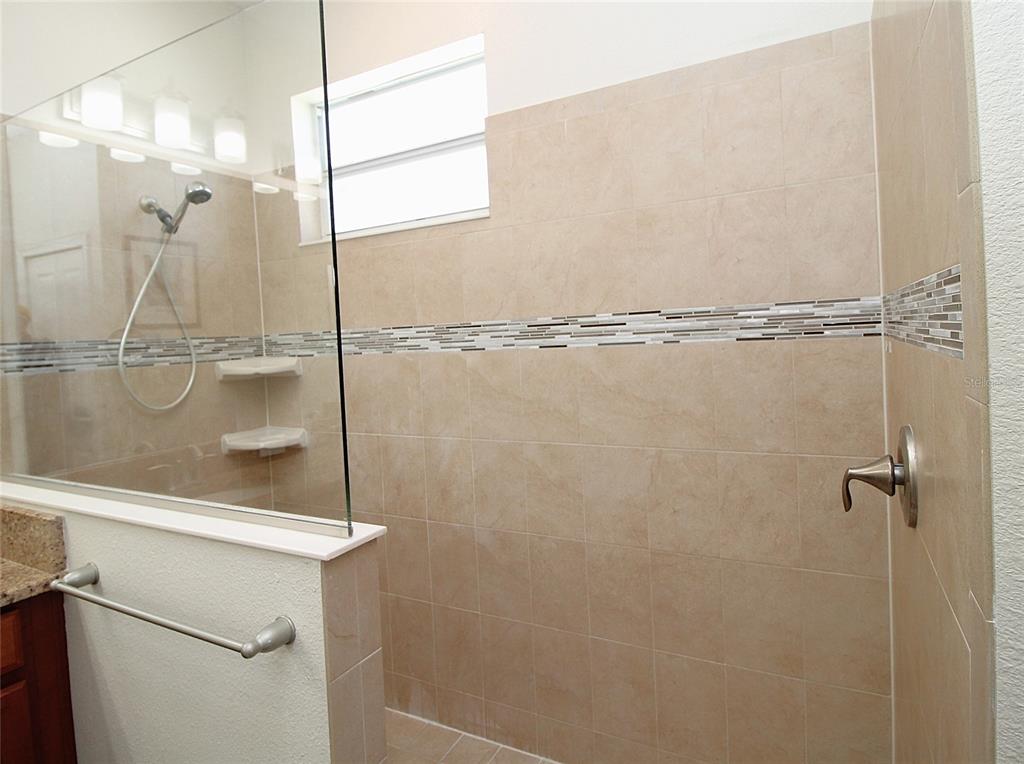 3752 Quaint Lane Clermont, FL 34711 - Photo 20 of 49 a bathroom with a glass shower door