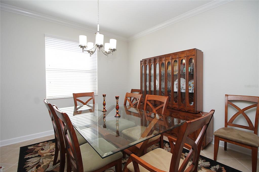 3752 Quaint Lane Clermont, FL 34711 - Photo 7 of 49 a dining room with furniture and a chandelier