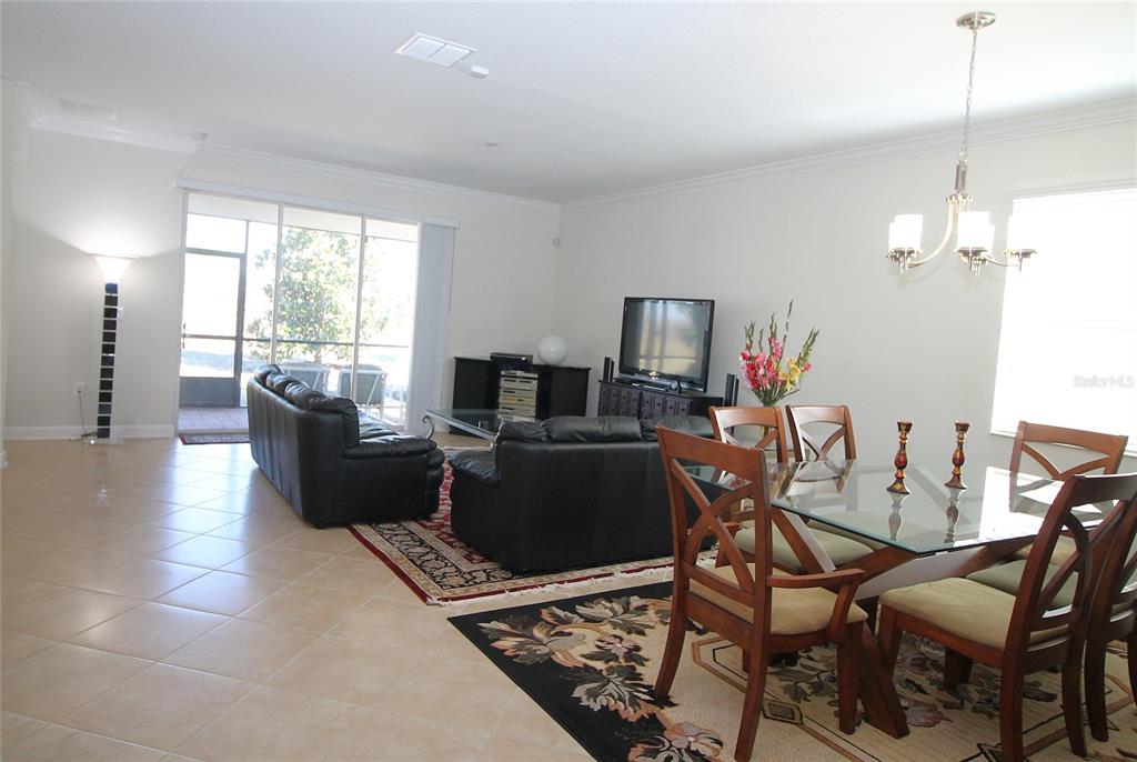 3752 Quaint Lane Clermont, FL 34711 - Photo 9 of 49 a living room with furniture and a chandelier