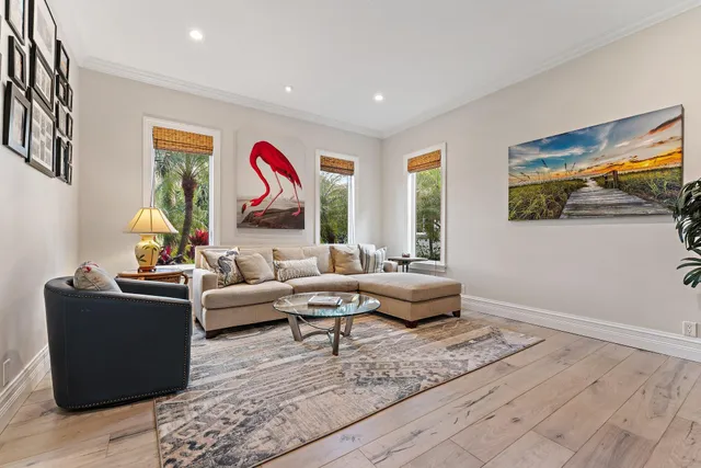 a living room with furniture and a hard wood floor