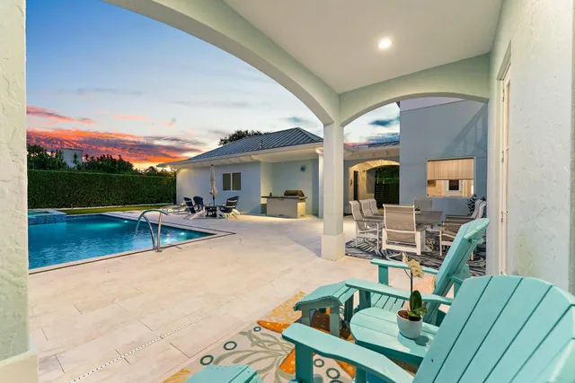 a view of house with swimming pool outdoor seating