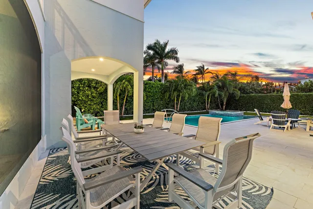 a view of a patio with a dining table and chairs with a patio