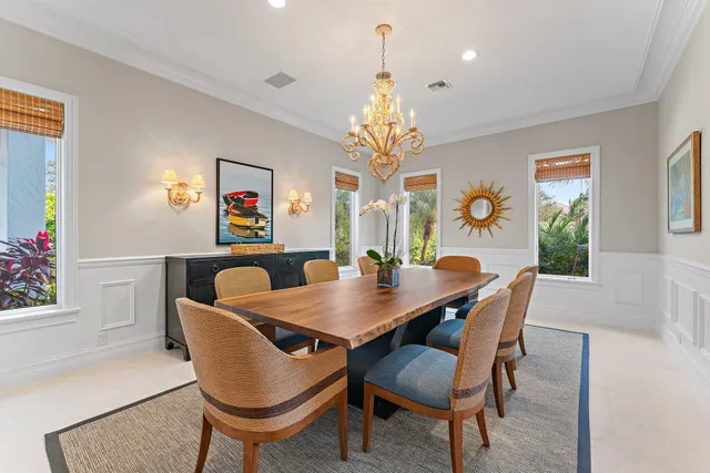 a view of a dining room with furniture and a chandelier