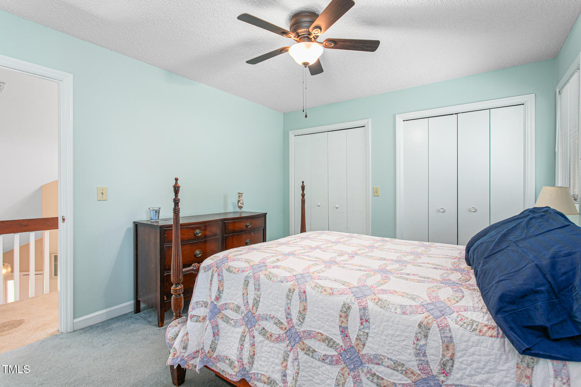 809 Brookview Drive Elon, NC 27244 - Photo 31 of 53 a bedroom with a bed and a chandelier