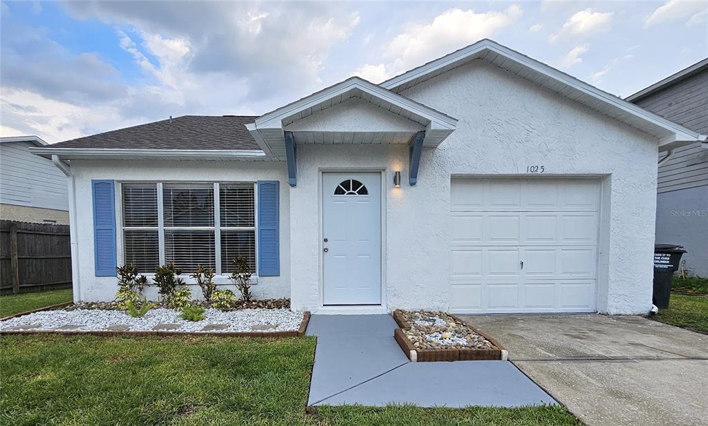 1025 Clovercrest Road Orlando, FL 32811 - Photo 1 of 27 a front view of a house with garden