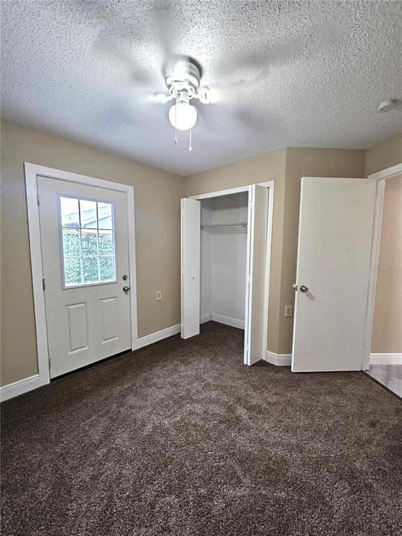 1025 Clovercrest Road Orlando, FL 32811 - Photo 11 of 27 an empty room with chandelier fan and windows