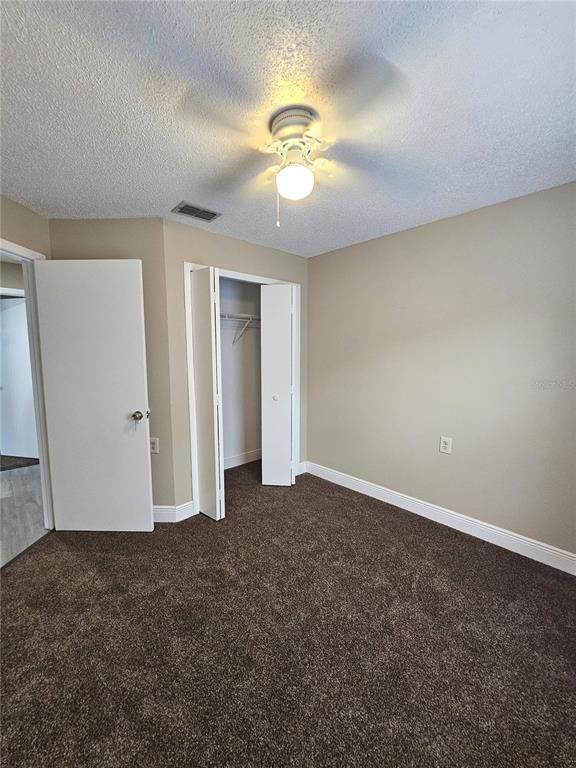 1025 Clovercrest Road Orlando, FL 32811 - Photo 13 of 27 a view of an empty room with a chandelier fan