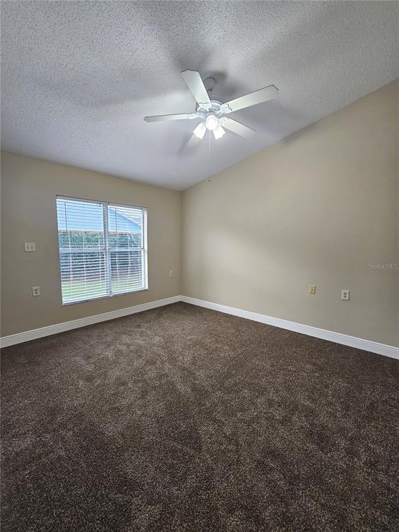 1025 Clovercrest Road Orlando, FL 32811 - Photo 15 of 27 an empty room with windows and fan