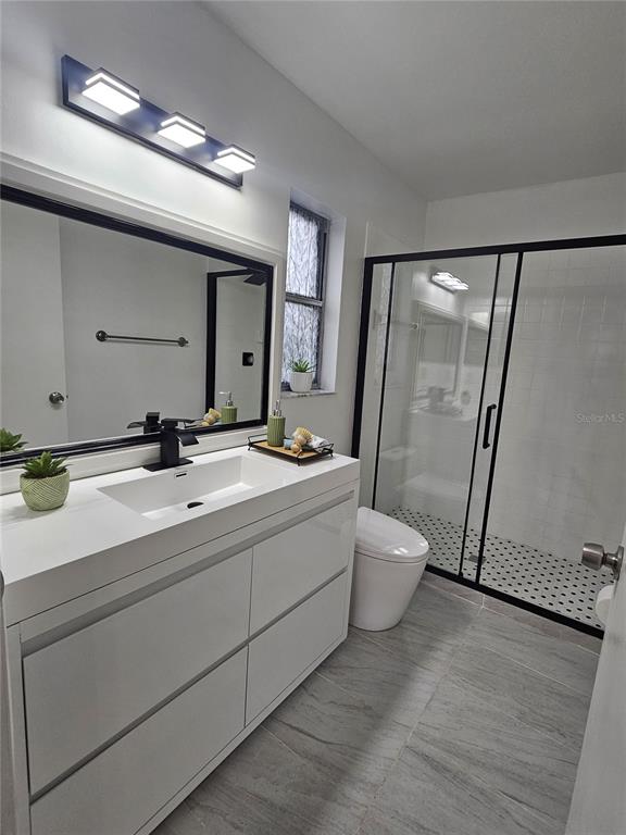 1025 Clovercrest Road Orlando, FL 32811 - Photo 17 of 27 a bathroom with a double vanity sink mirror double and shower