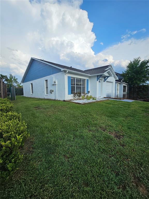 1025 Clovercrest Road Orlando, FL 32811 - Photo 21 of 27 a view of a house with a big yard and large trees
