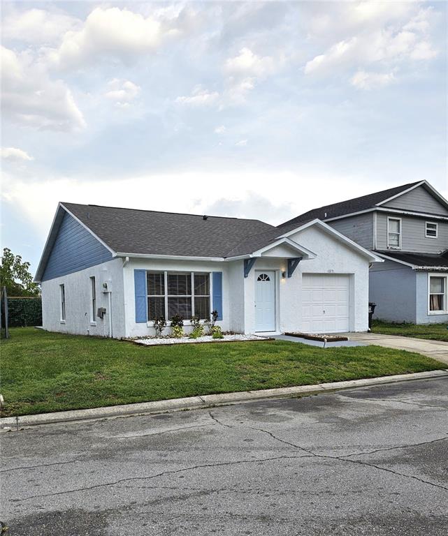 1025 Clovercrest Road Orlando, FL 32811 - Photo 3 of 27 a front view of a house with a yard and garage
