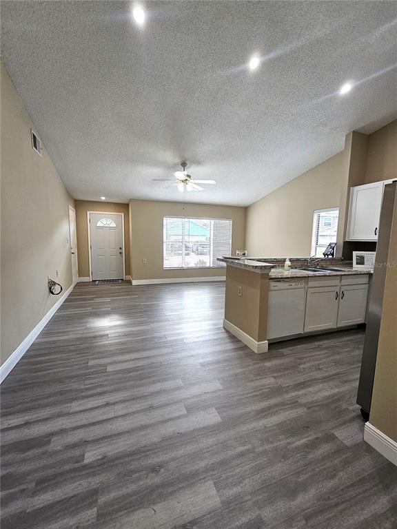 1025 Clovercrest Road Orlando, FL 32811 - Photo 4 of 27 a view of a kitchen center island wooden floor and living room