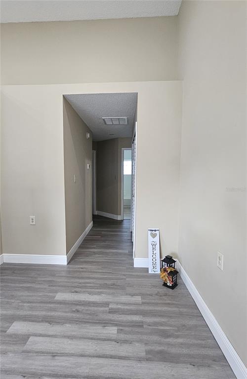 1025 Clovercrest Road Orlando, FL 32811 - Photo 8 of 27 a view of a livingroom with wooden floor and shoes